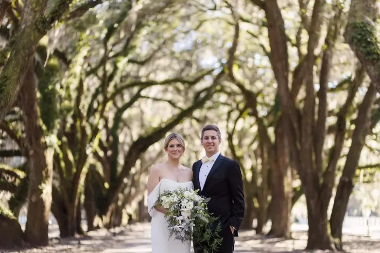 Couple walking an oak-lined lane