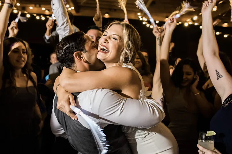 Bride hugging a friend on the dance floor